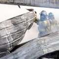 HOT TIN ROOF - Rogers firefighters pour water into a metal shed that burned shortly after noon Tuesd...