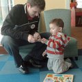    Alan Gallardo, 19 months, gets a little help from his dad Adolfo Gallardo (cq) as he puts togethe...
