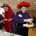  
Betty Miller of Rogers fills her plate Wednesday during a tea party for members of the Red Hat So...