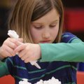  Marley Hudspeth, 7, decorates her cupcakes Wednesday with other children from Happy Hollow Elementa...