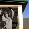  Sean Scott builds the frame for an exterior wall Wednesday on a building at 903 Lilac St. in Rogers...