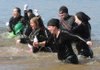 A group calling themselves the Ninja's quickly escape after dousing themselves in the 39-degree waters of Beaver Lake during the Polar Bear Plunge at Prairie Creek Park in 2009.