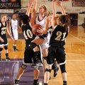 Fayetteville’s Sierra Shipley, center, leaps between Bentonville defenders Blaklee Sanders, left, an...