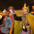 Rufus Herndon throws beads to the crowd during the Demented Krewe’s celebration of Mardi Gras on Dic...