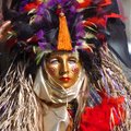 A member of the Krewe of Olympia waits for the start of the Fat Saturday Parade of Fools on Dickson ...