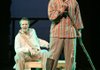 Runaway slave Jim, played by Justin Stewart, right, and Huck Finn, played by Ramond Curtis, float on a raft down the Mississippi River in the Rogers Little Theater’s production of “Big River,” which opens this weekend.