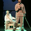 Runaway slave Jim, played by Justin Stewart, right, and Huck Finn, played by Ramond Curtis, float on...
