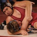 Springdale High’s Jhony Goodinez works on pinning Springdale Har-Ber’s Ezra Ward during a Feb. 2 mat...