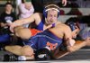 Rogers High’s Jake Humphries, top, works against Rogers Heritage’s Francisco Simental during their 119-pound match on Feb. 6 at the Fayetteville Invitational at Fayetteville. Humphries won the match by decision.