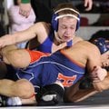 Rogers High’s Jake Humphries, top, works against Rogers Heritage’s Francisco Simental during their 1...