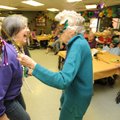 MARDI GRAS CELEBRATION - Jane Ledbetter, administrator at Fayetteville City Hospital, left, dances F...