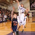 Fayetteville High’s Kikko Haydar, right, lays the ball in the basket after being fouled by Rogers He...