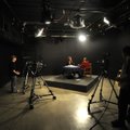 Mark Warren, left, and C.F. Roberts operate cameras Friday as Shannon Caine, center right, interview...