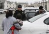 LANGUAGE AID - Springdale Police officer Gomez Zackious speaks Marshallese to a woman Thursday to explain why her husband is being investigated on suspicion of a hit-and-run in Springdale.