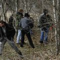 Bentonville police and Benton County sheriff’s deputies comb a wooded area on Sugar Creek Road just ...