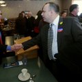 Judicial candidates Gary Carson, left, and Steve Zega shake hands Tuesday after squaring off in a ca...