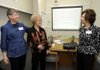 Eliseia Arnold, right, and Elaine Casey, left, both board members for the Christian Women’s Job Corps of Northwest Arkansas, greet founding board member Lois Baker of Bella Vista on Saturday. They were welcoming guests to an open house event at the nonprofit organization’s training site in downtown Rogers.