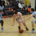 Rogers Heritage’s Mac Olinger, center, drives to the basket as Fort Smith Southside’s Cameron Adams,...