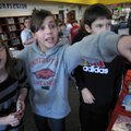 THERE IT IS! - Anistyn Nickell, center, points to a shelf of books as she and Caroline McCane, left,...
