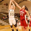 Bentonville’s Whitney Sandmann, left, goes for a lay up shot guarded by Springdale High’s Jasmine Gi...