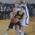  Jalen Beeks of Prairie Grove moves for the basket around Pea Ridge defender Cameron Thompson during...