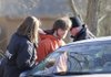  Two officers with the Benton County Sheriff’s Office arrest Nicholas Johansen in connection with capital murder Wednesday after he attempted to pass a roadblock on Sugar Creek Road near Garfield. Investigators were digging up a shallow grave on nearby property where they suspect the remains of two missing women are buried.
