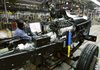 Detroit Chassis assembly line worker Deirdre Dudley works on a RV chassis in Detroit. Wholesale prices shot up at double the expected pace in January, propelled higher by big increases in energy costs. 
