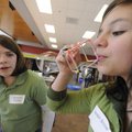 Savannah Bledsoe, left, watches as her friend Lauren Snow blows a soap bubble Thursday at the Univer...