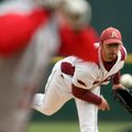 Arkansas starting pitcher Mike Bolsinger delivers the first pitch of the season against Ball State o...