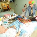  Marion Cowan of Prairie Grove, right, hands a lap robe to Jerry Lee of Alpena, left, as Lee’s son, ...