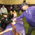  Fayetteville High volunteer assistant baseball coach Kent Ariola, right, congratulates senior Clark...