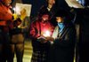  Mary, right, and Rosemary Sulzen light a candle during the 40 Days for Life kick-off rally Tuesday on College Avenue in Fayetteville.
