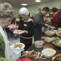  Members of the German American Club of Northwest Arkansas fix plates of food Feb. 14 while celebrat...