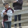  A rainbow trout caught by Tiffany Veloz, right, is hoisted over the head of Ally Estrada during a C...