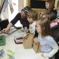  A group of Girl Scouts learn Friday about the country Kuwait during World Thinking Day at the Bento...