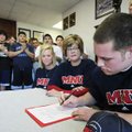  Springdale Har-Ber’s Jacob Lloyd, right, signs a letter of intent to play football at MidAmerica Na...