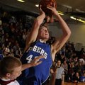  Rogers High junior guard Graham Parker shoots over Springdale senior forward Joseph Kellogg in the ...