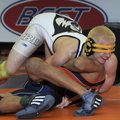 Bentonville’s Drew Coble has his headgear slip over his eyes while wrestling Rogers Heritage’s Peter...