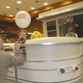  Ray Evans of Rogers and his son, Austin, play with a balloon Saturday while looking at boats at the...