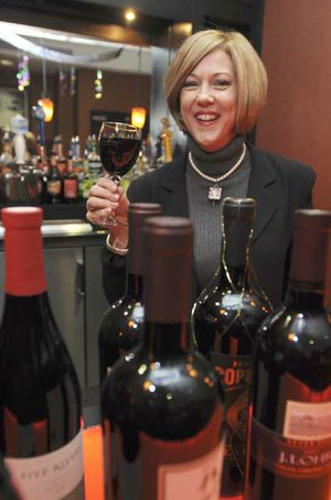  Allison Brock, co-chairwoman of the third annual Cystic Fibrosis Foundation Wine Opener, poses Wednesday for a photograph at the Doubletree Guest Suites in Bentonville. The fundraising event will be at Doubletree on Friday.