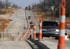  Traffic travels on a reduced Wagon Wheel Road on Thursday in Springdale. The road is the last to be improved as part of the city’s street bond program.