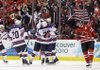  USA's Brian Rafalski is congratulated in front of Canada's Sidney Crosby (87) after Rafalski scored his second goal of the game in the first period of a preliminary round men's ice hockey game at the Vancouver 2010 Olympics in Vancouver, British Columbia, Sunday