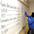Financial aid worker Caress Nicholas from NorthWest Arkansas Community College prepares a white boar...