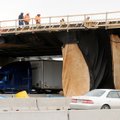 BRIDGING THE GAP - Work continues Friday on the Interstate 540 overpass where Olive Street in Rogers...