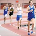 Rogers senior Jeremiah Fleeman leads a pack of runners down a straightaway while competing in the 3,...