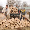 Arthur Rainwater and his mother, Betty Lawson, unload a pickup full of oak firewood at a client’s re...
