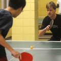 Jan Martemsson, right, a University of Arkansas visiting professor from Sweden, plays table tennis T...