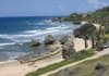 Surf rolls in along a sandy shore in Barbad