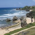 Surf rolls in along a sandy shore in Barbad