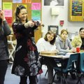 Christina Herbold, middle, congratulates a man Tuesday on giving the correct answer while showing pa...